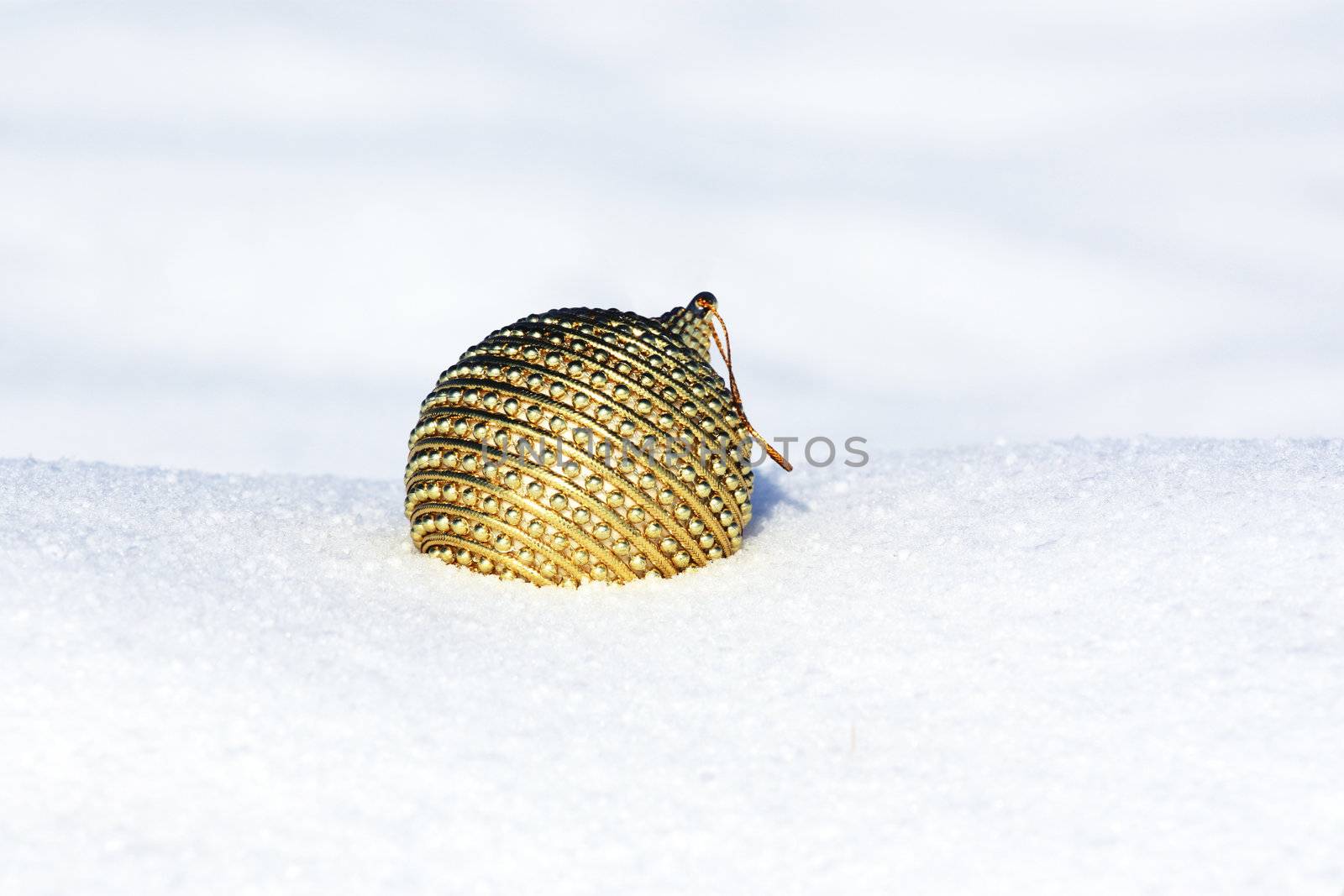 christmas ball in snow by photochecker