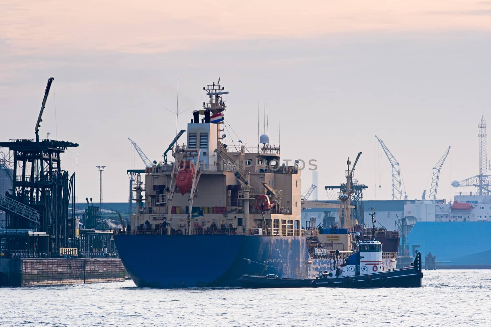 Tanker in harbor with tug by Colette