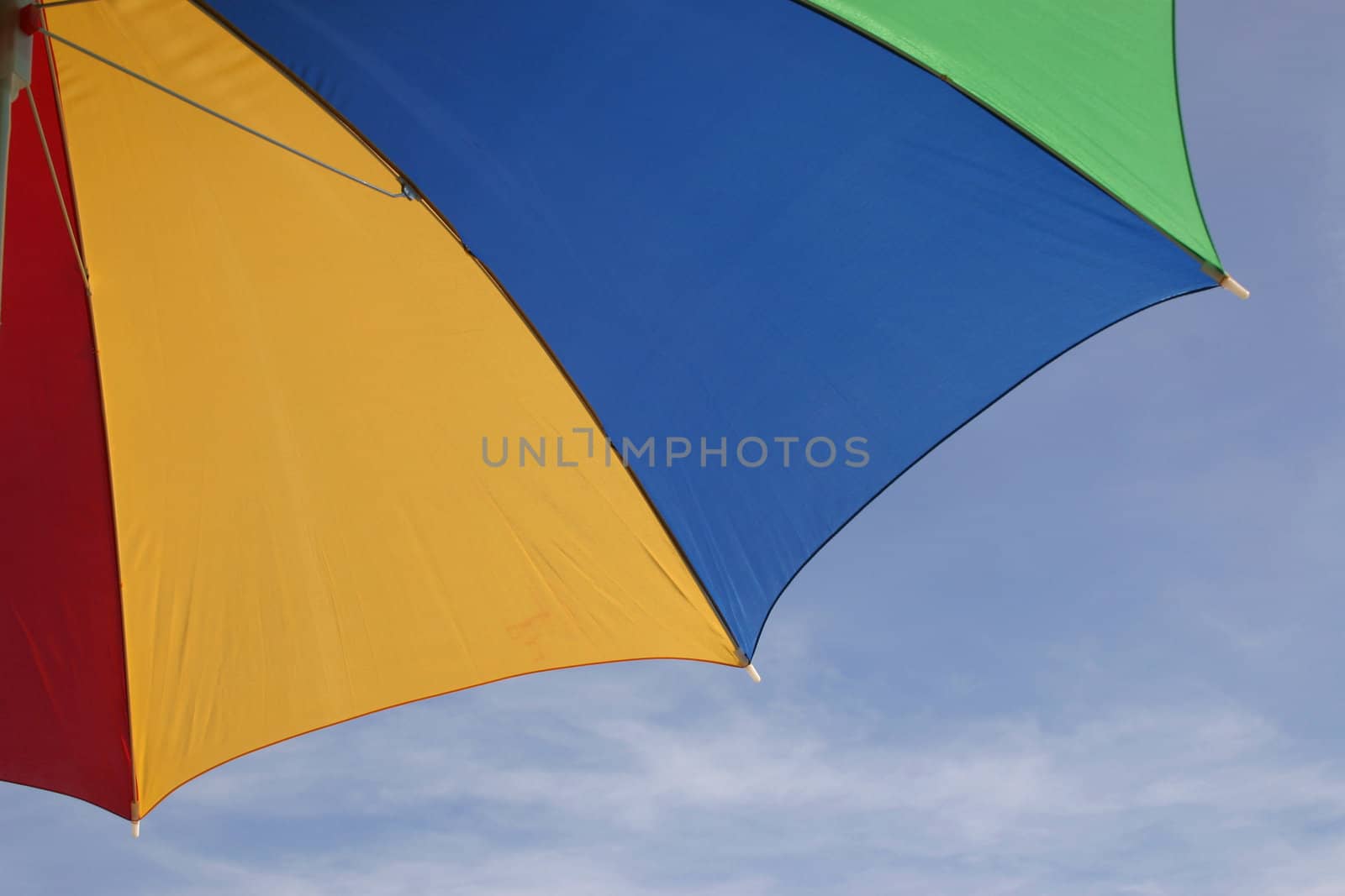 coloured parasol against the blue sky