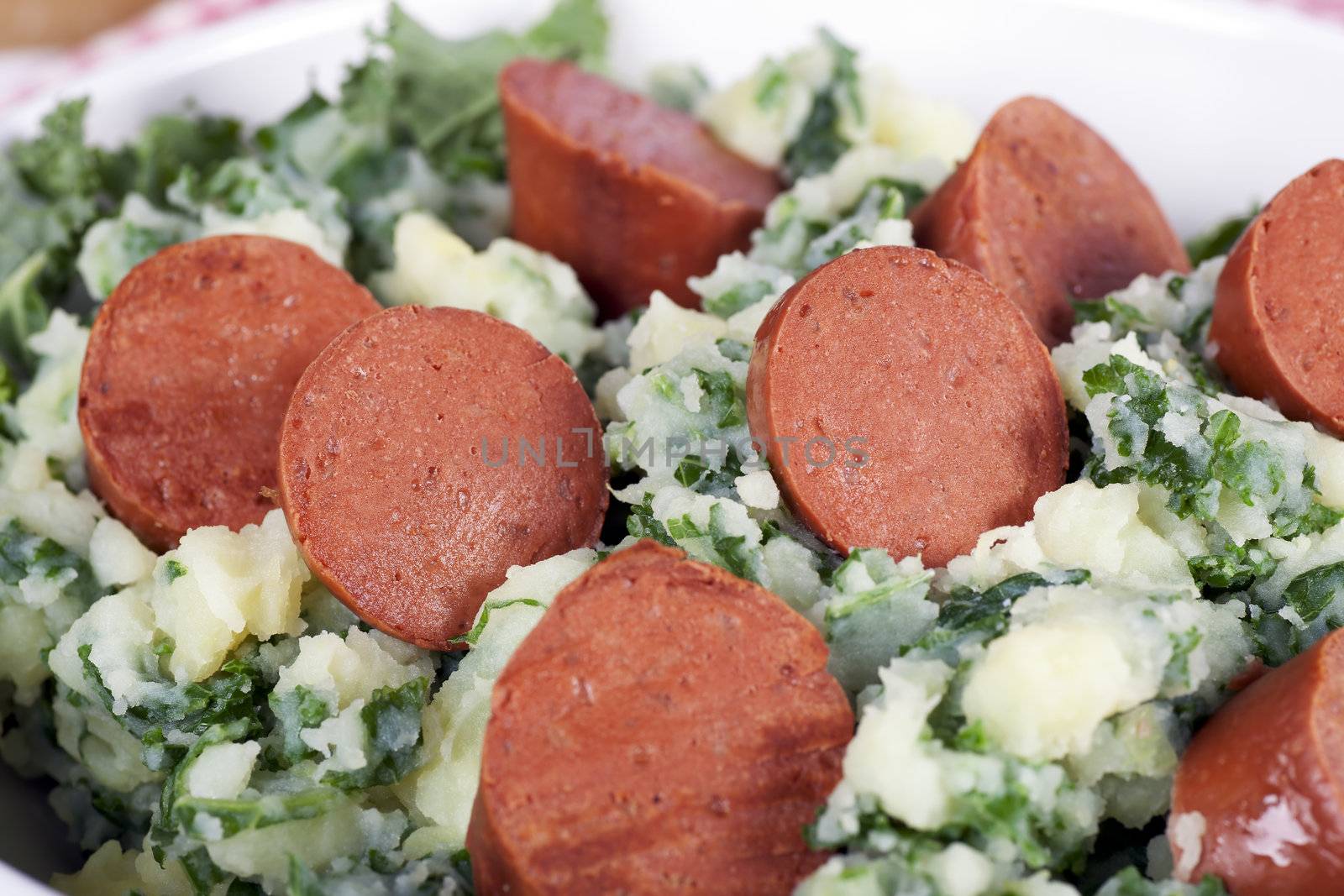 Dutch stamppot, mashed potatoes with kale, topped with vegetarian sausage.