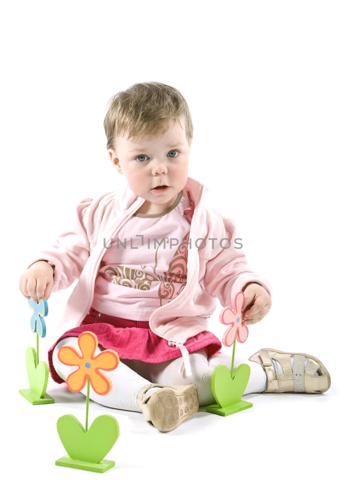 Child with wooden flowers. Isolated on white