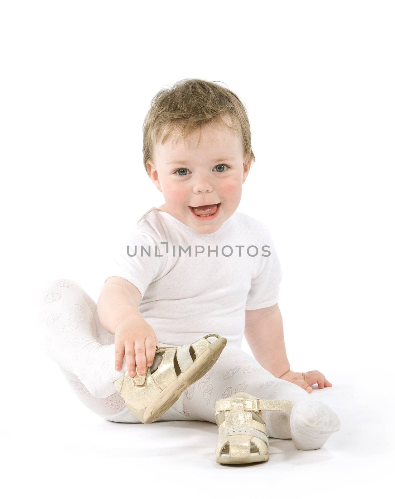 Child with shoes sitting. Isolated on white