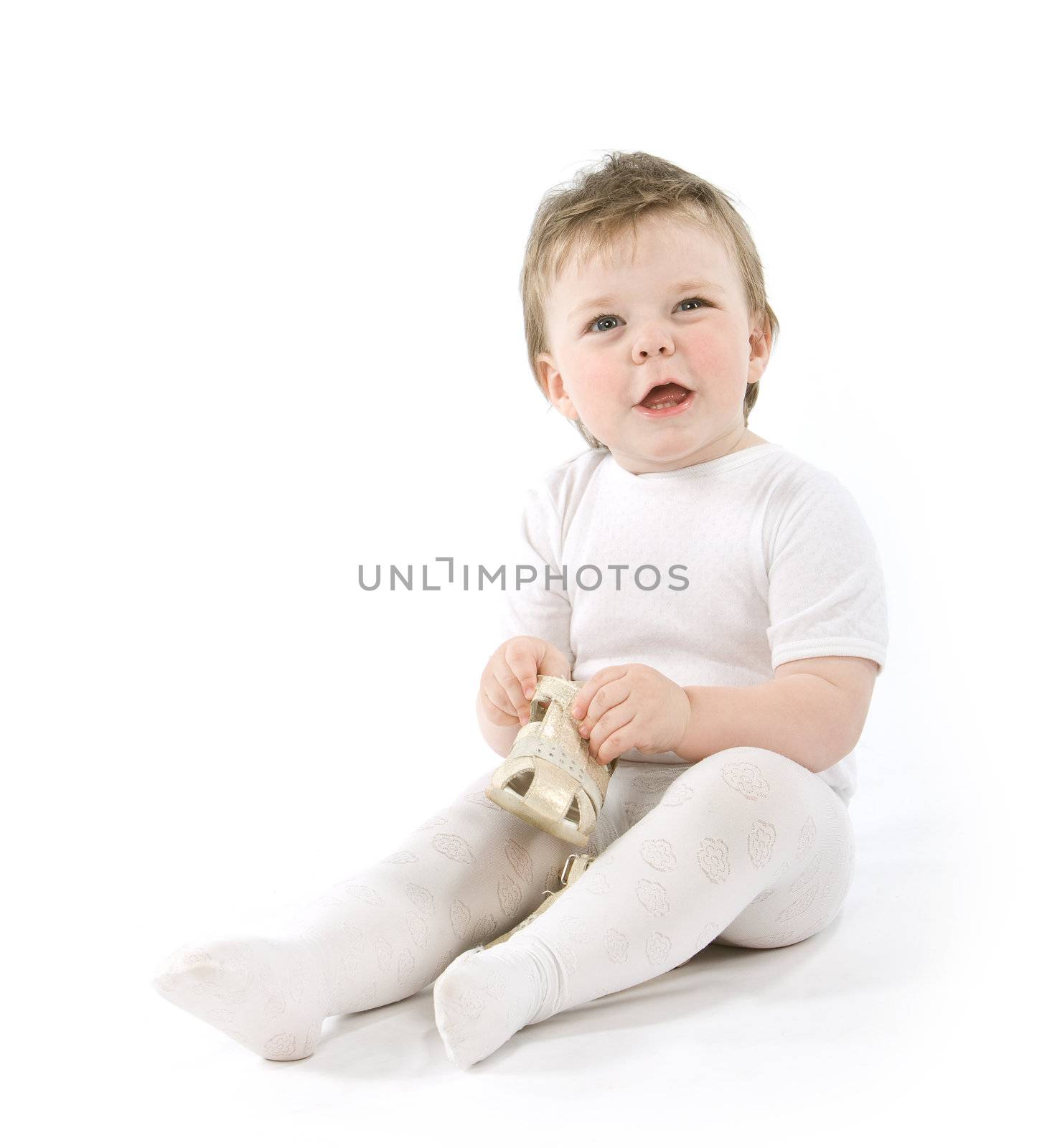 Child with shoes sitting. Isolated on white