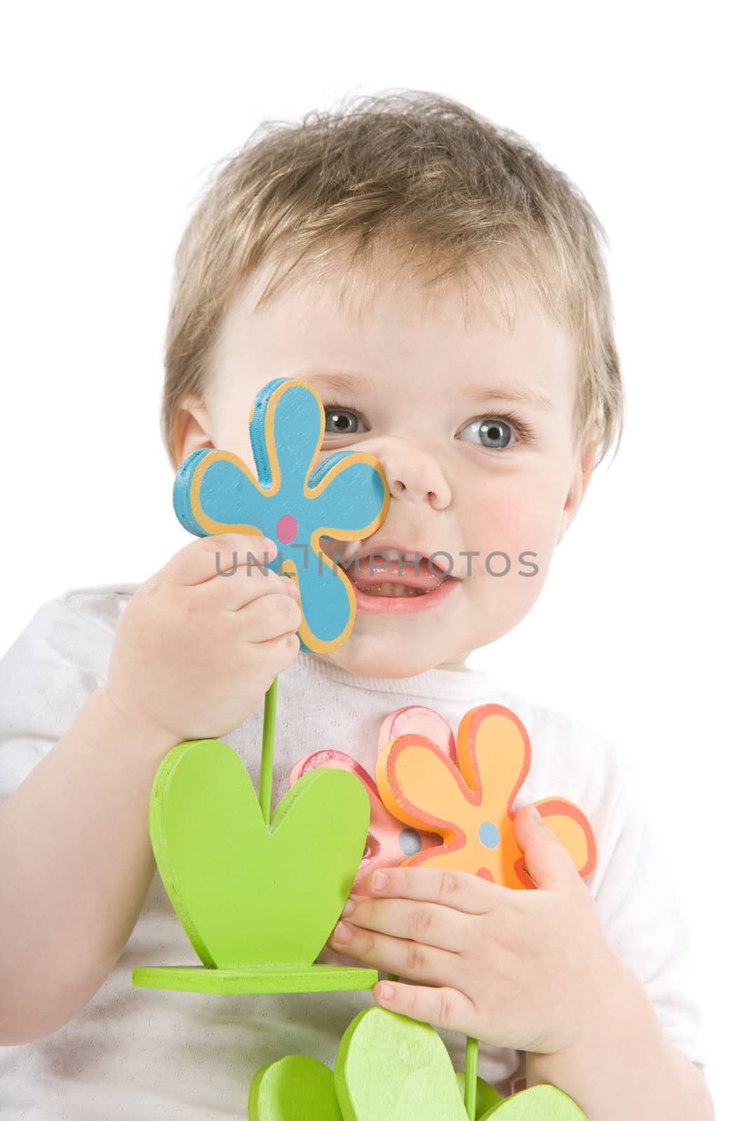 Child with wooden flowers. Isolated on white