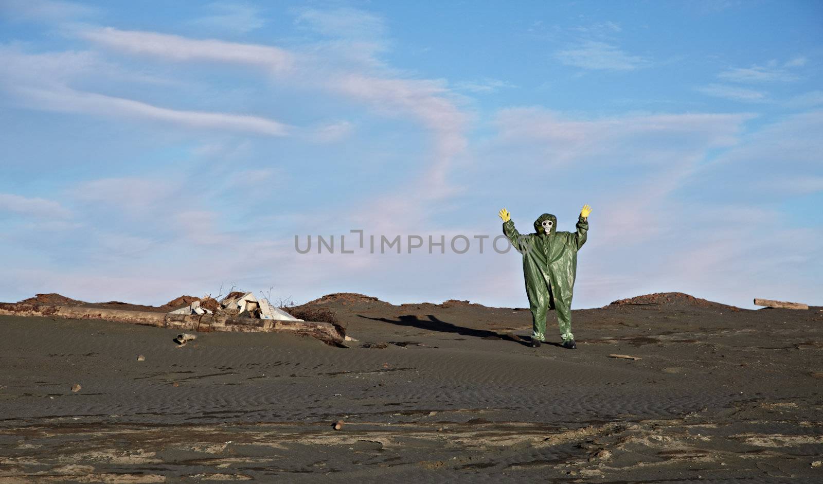 A man in overalls like an alien on desert