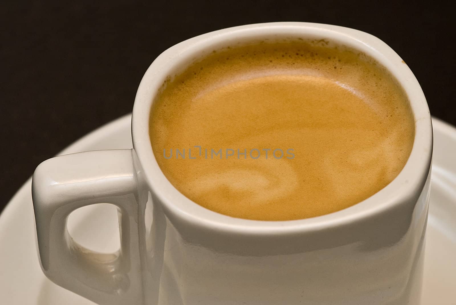 A cup of coffee on a black background.