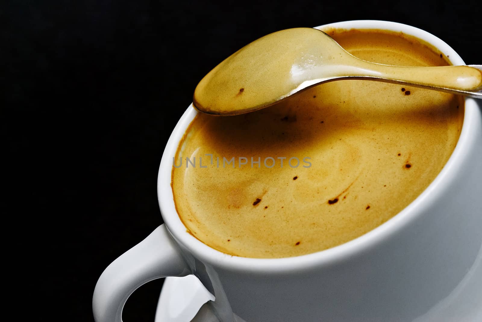 A cup of coffee on a black background.