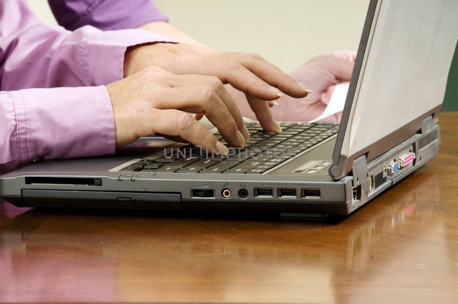 women using a laptop as a team or in a meeting;