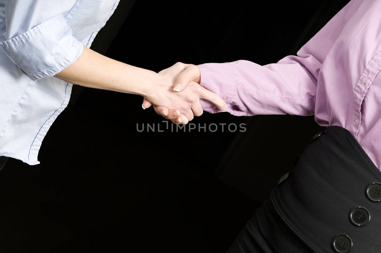 two womens hands shaking or grasping each other