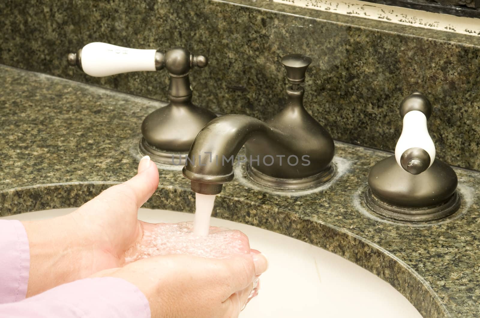 running water and a woman washing her hands