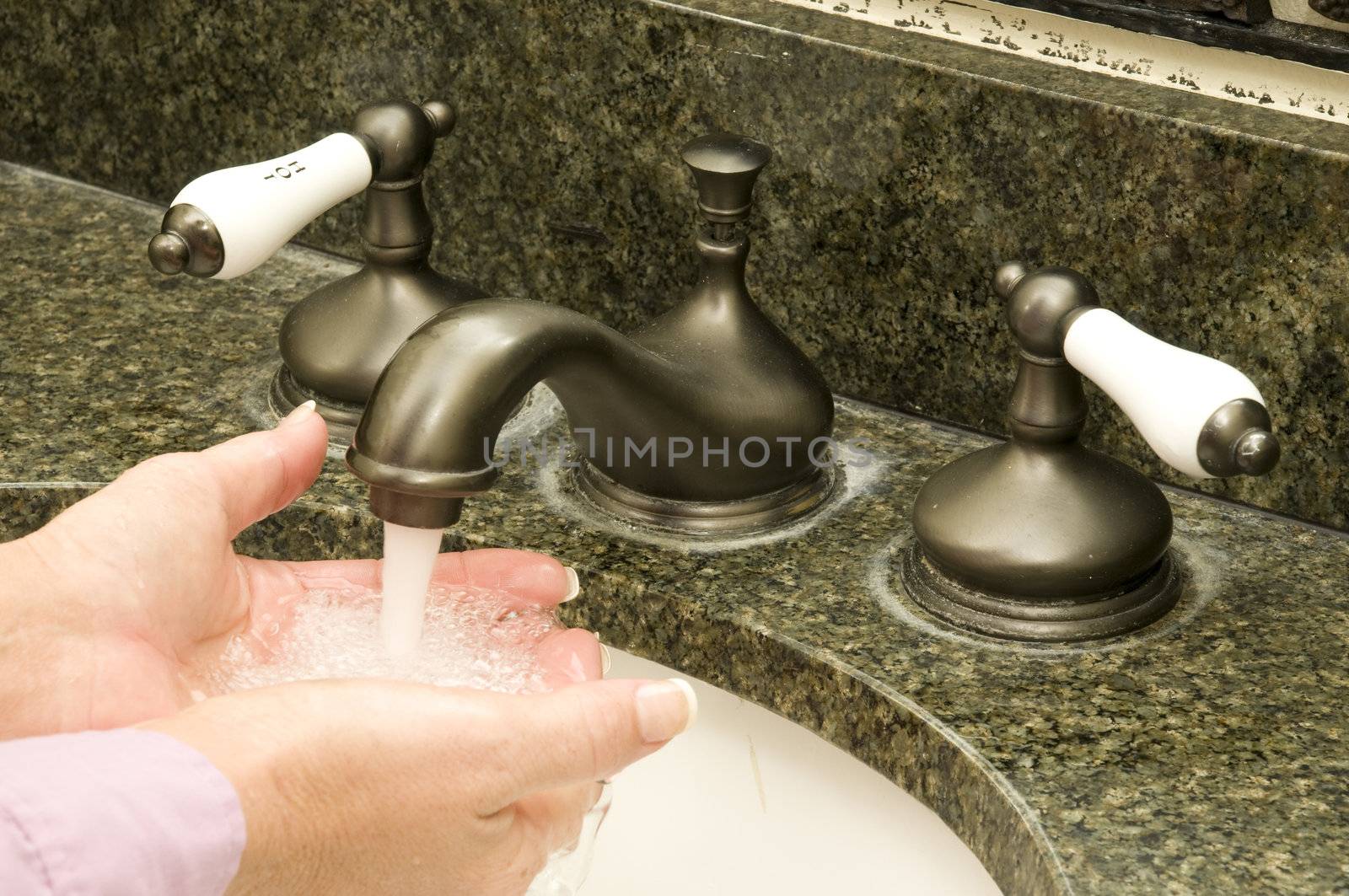 person washing their hands to keep germs away