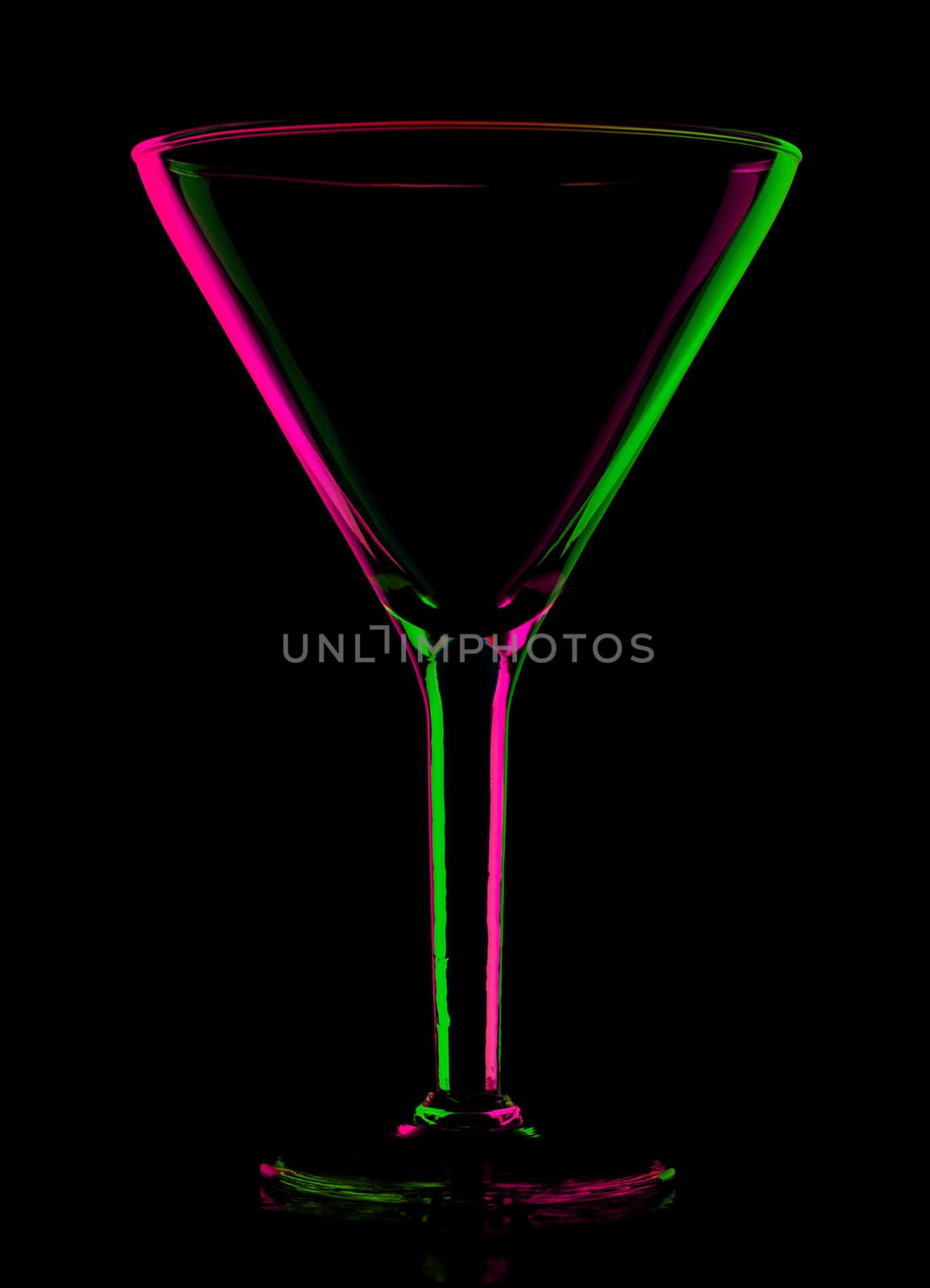 transparent colored empty martini glass, isolated on black