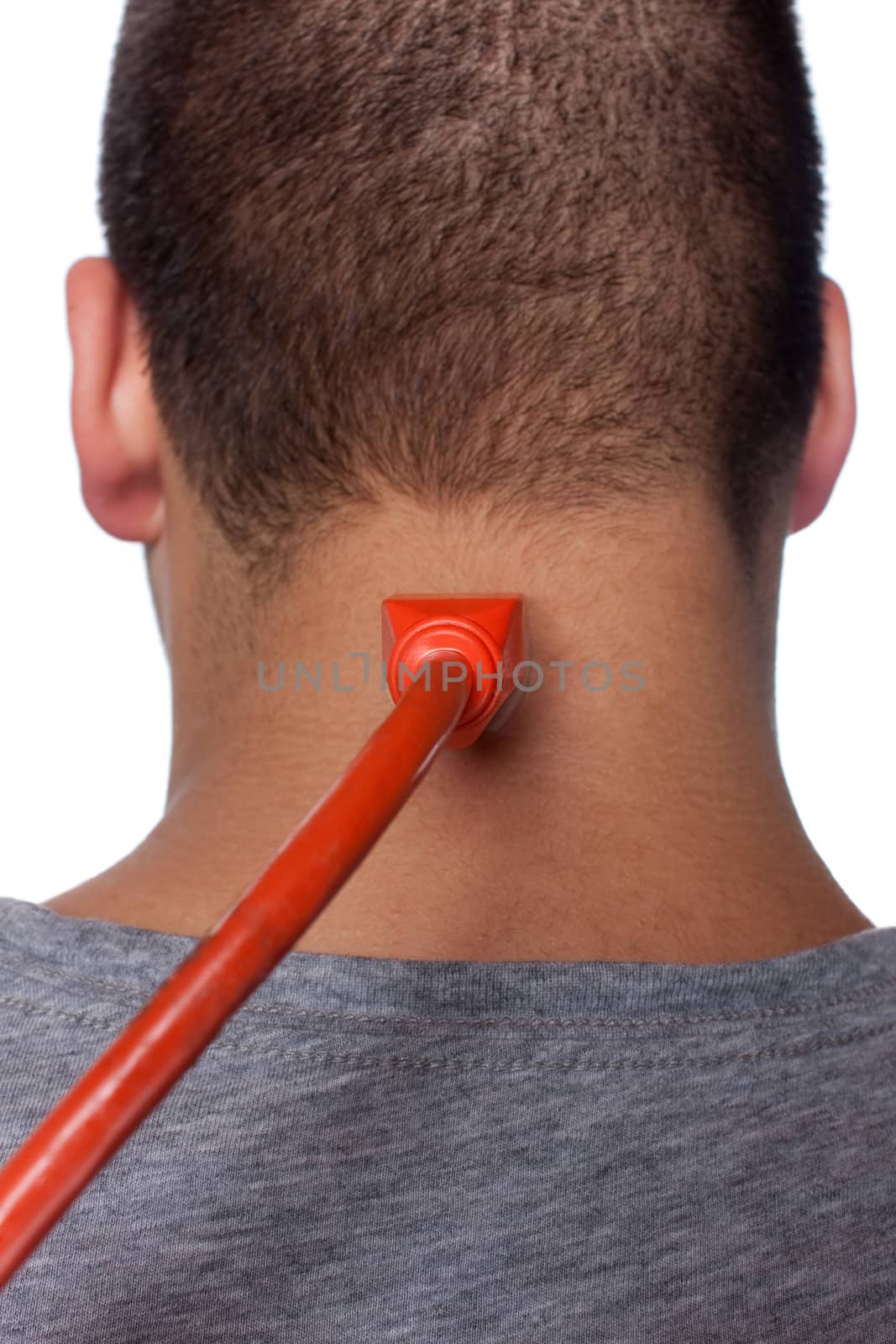 Conceptual image of a young man with an electrical cord plugged into electrical socket on the back of his neck.