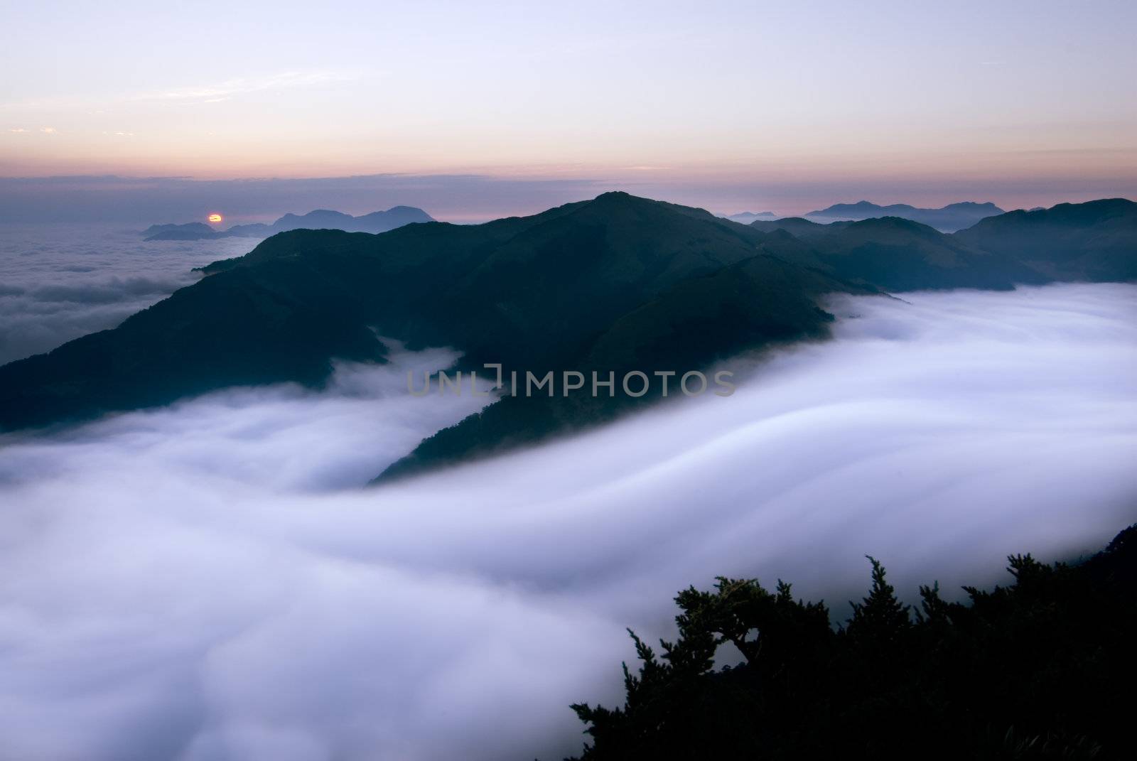 It is beautiful mountain landscape full of clouds.