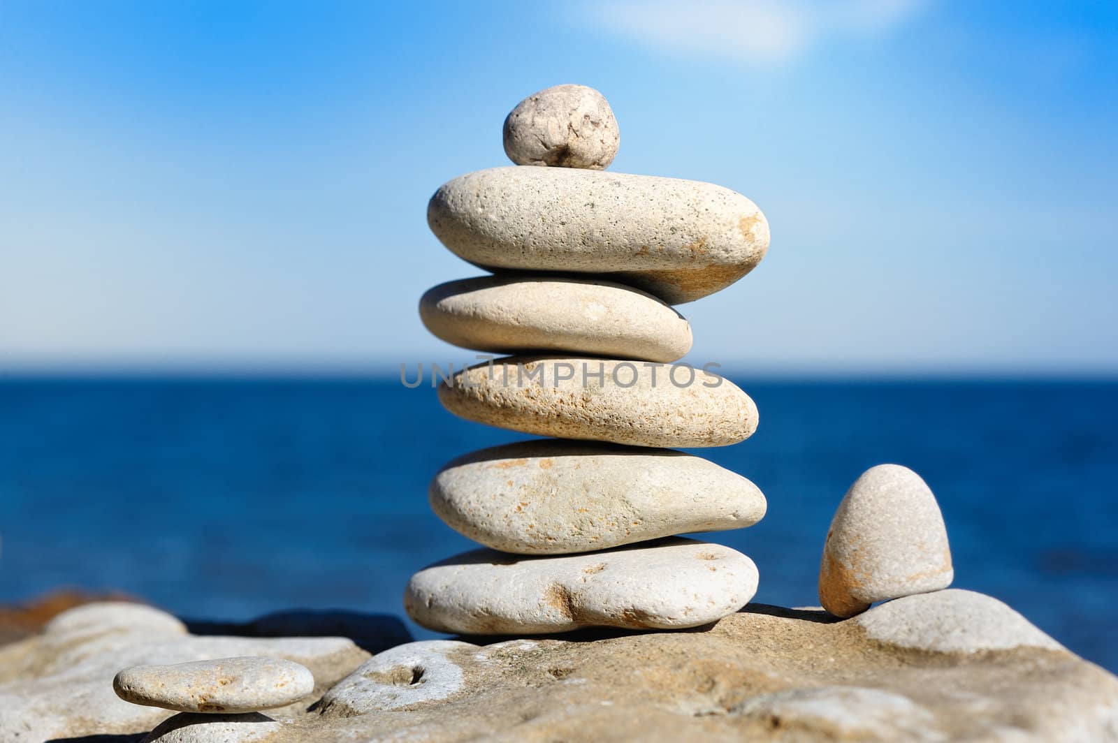 Several white pebbles one after another on a rock