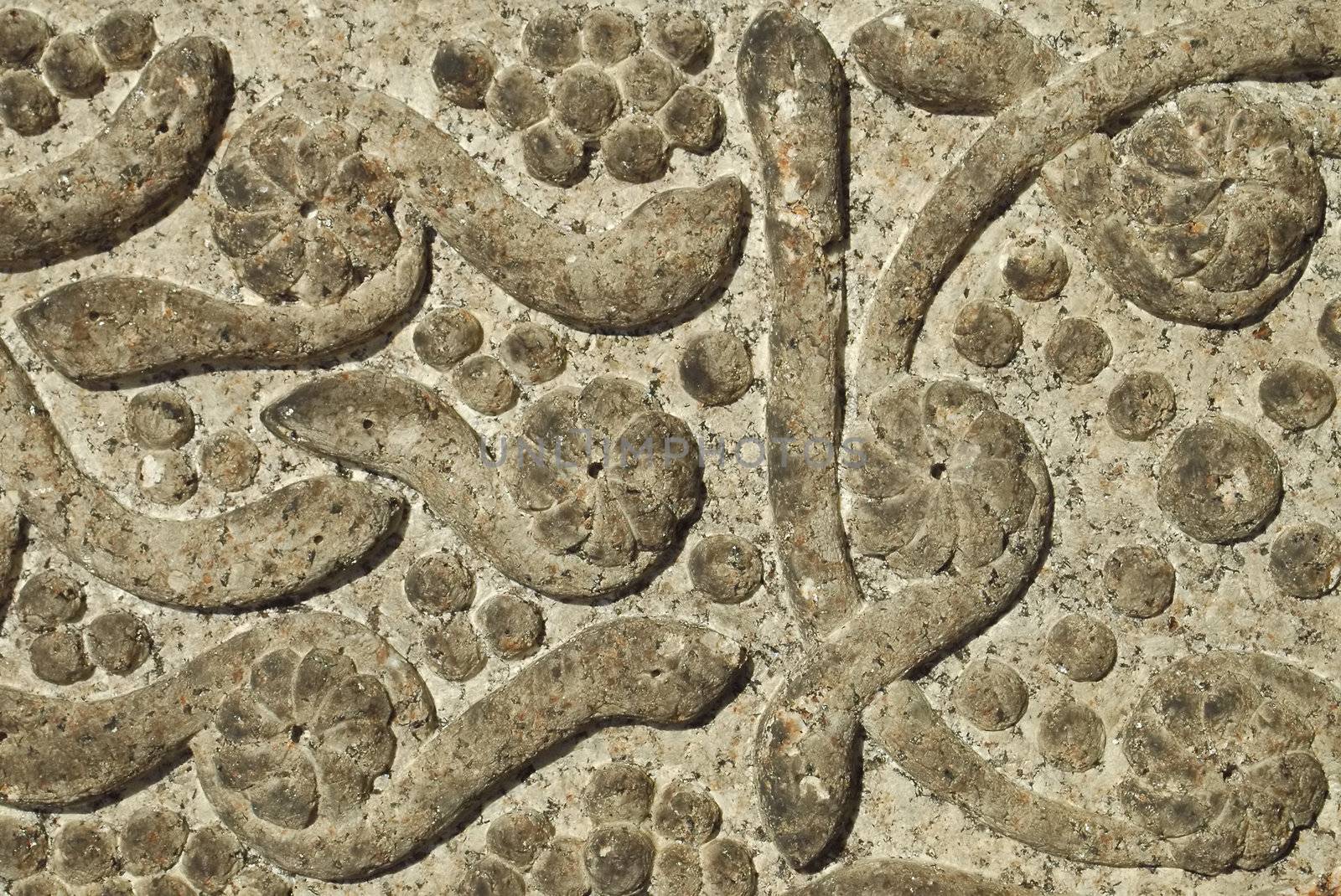 background of serpent creatures carved in stone