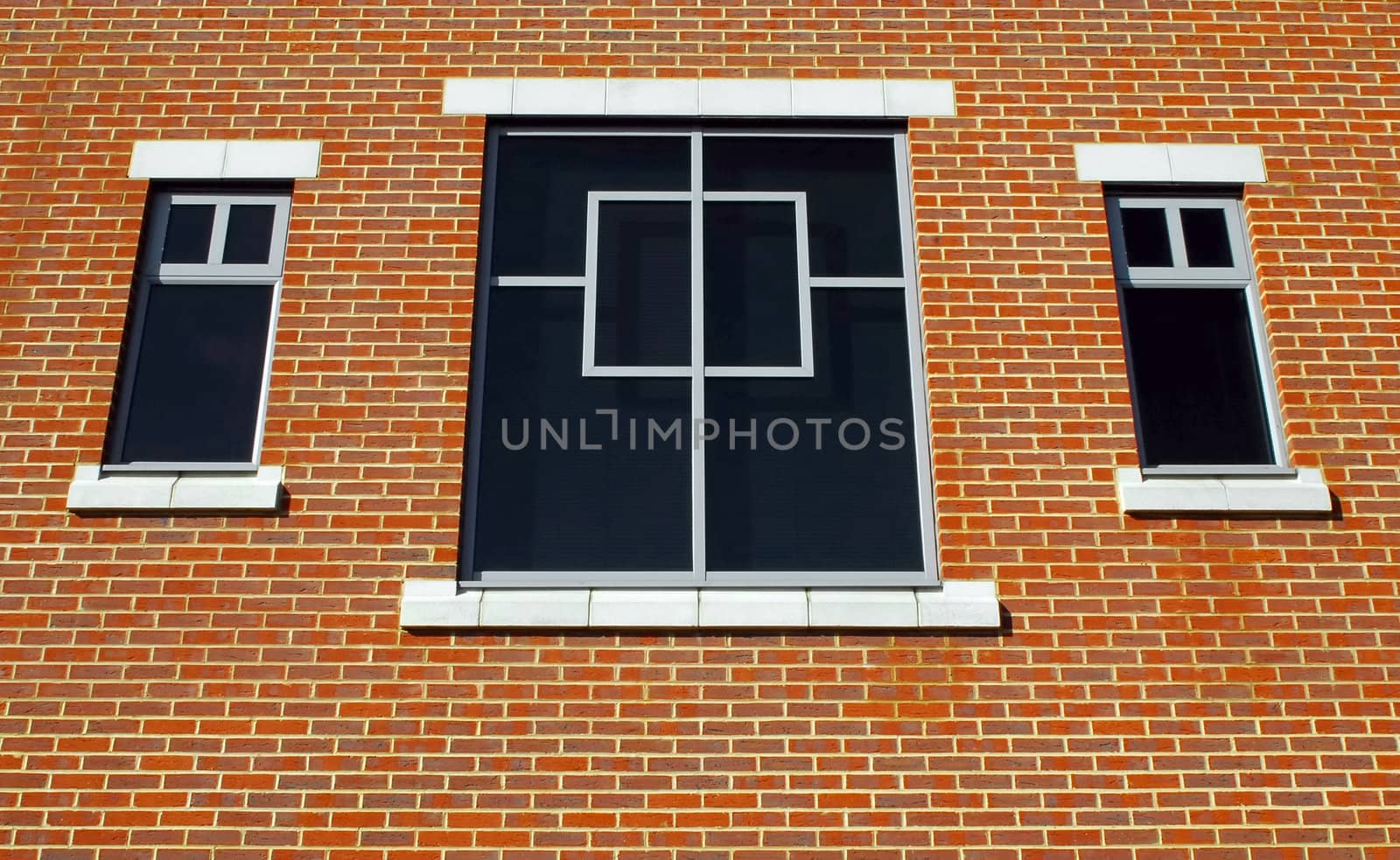 three window and simple brick wall architecture