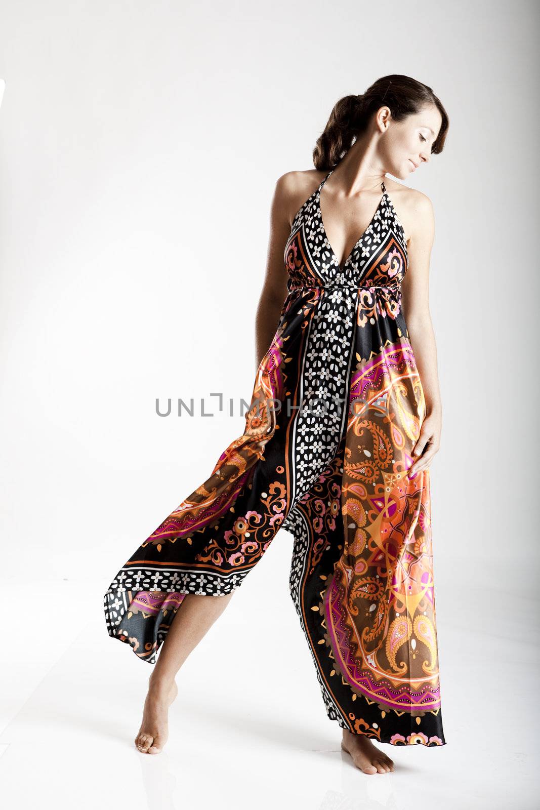 Beautiful fashion woman posing with a colorful dress