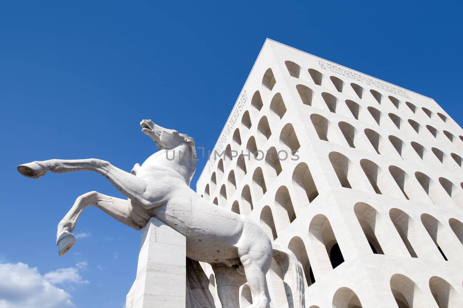 Squared colosseum with a horse statue - Eur zone - Rome Italy. wide angle perspective.