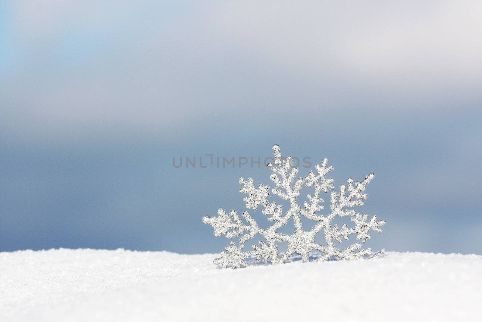 beautiful silver snowflake in snow