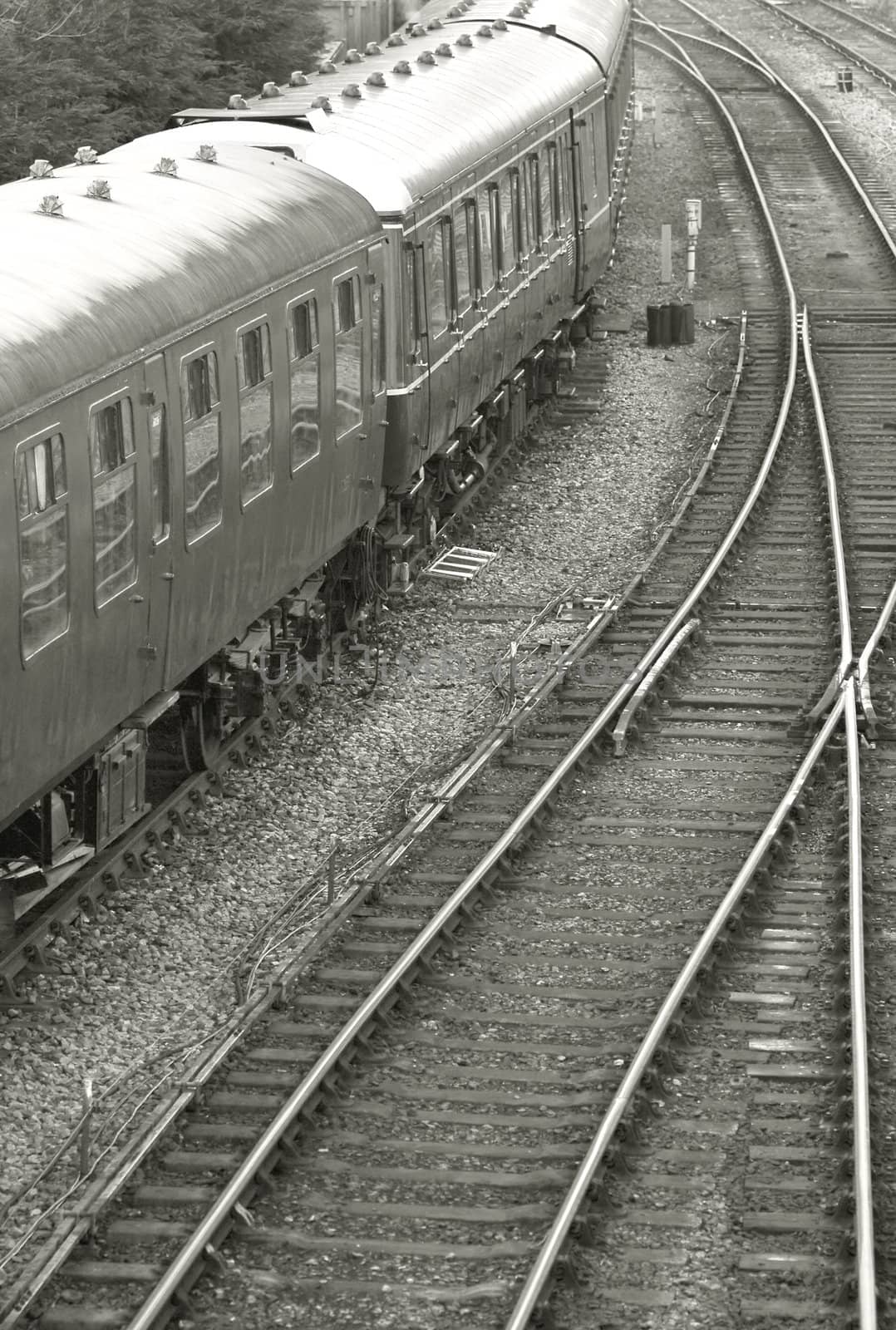 vintage train carriages with tracks curving into the distance