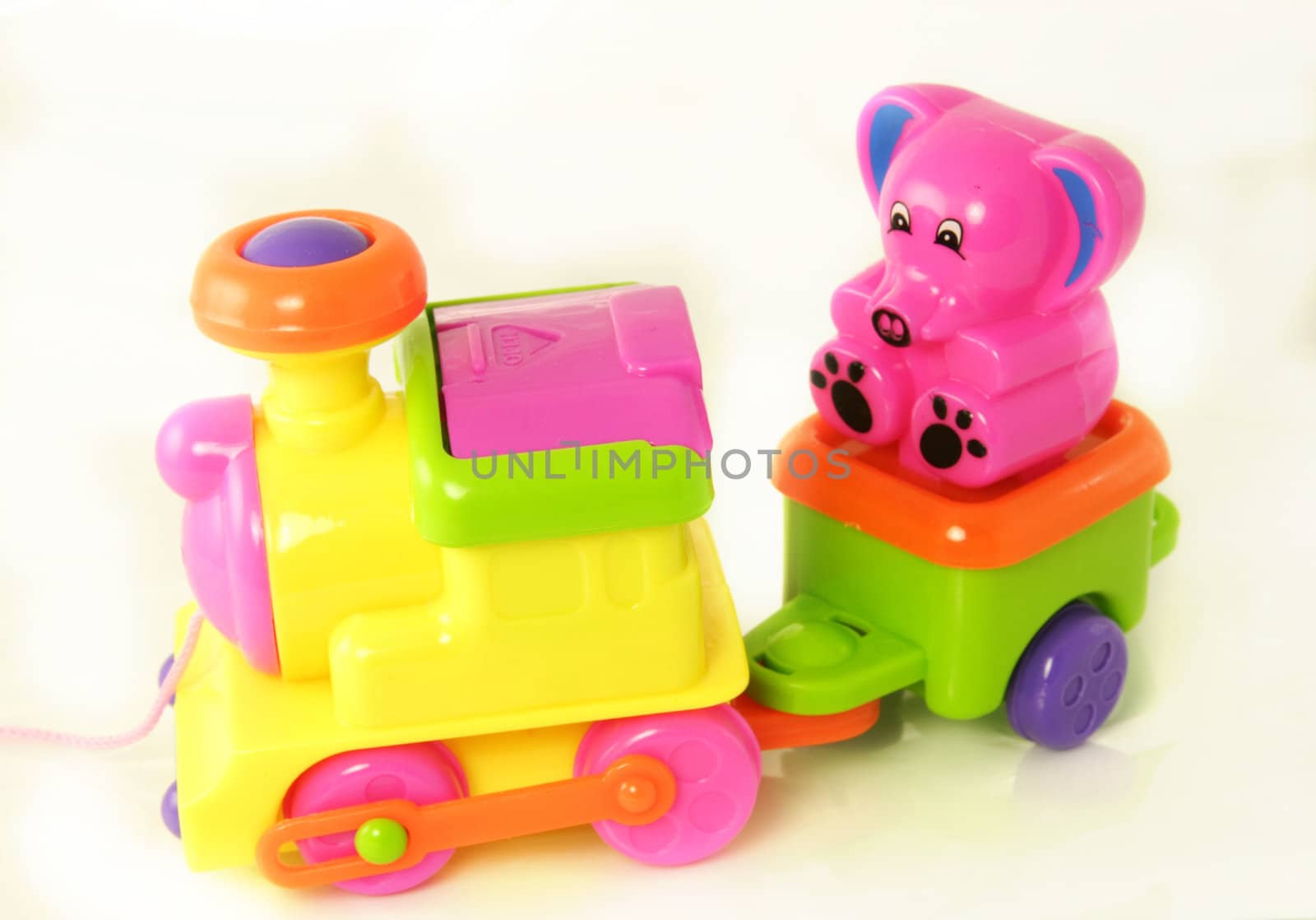 plastic toy train with a small teddy 