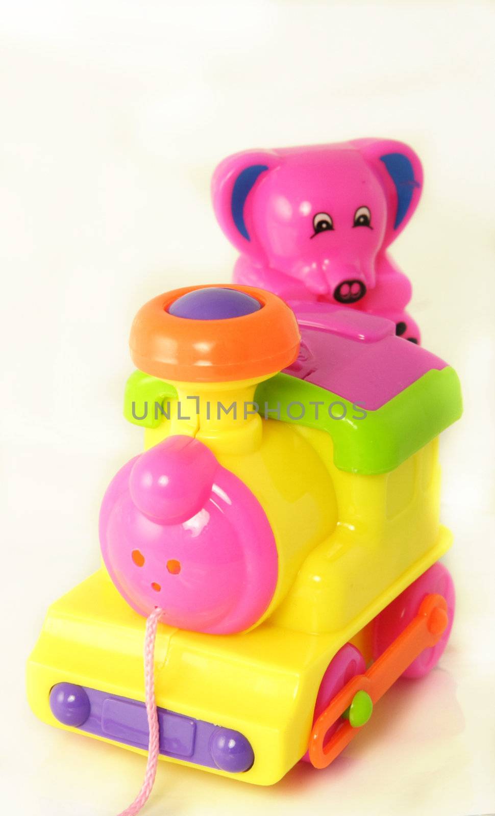 plastic toy train with a small teddy 