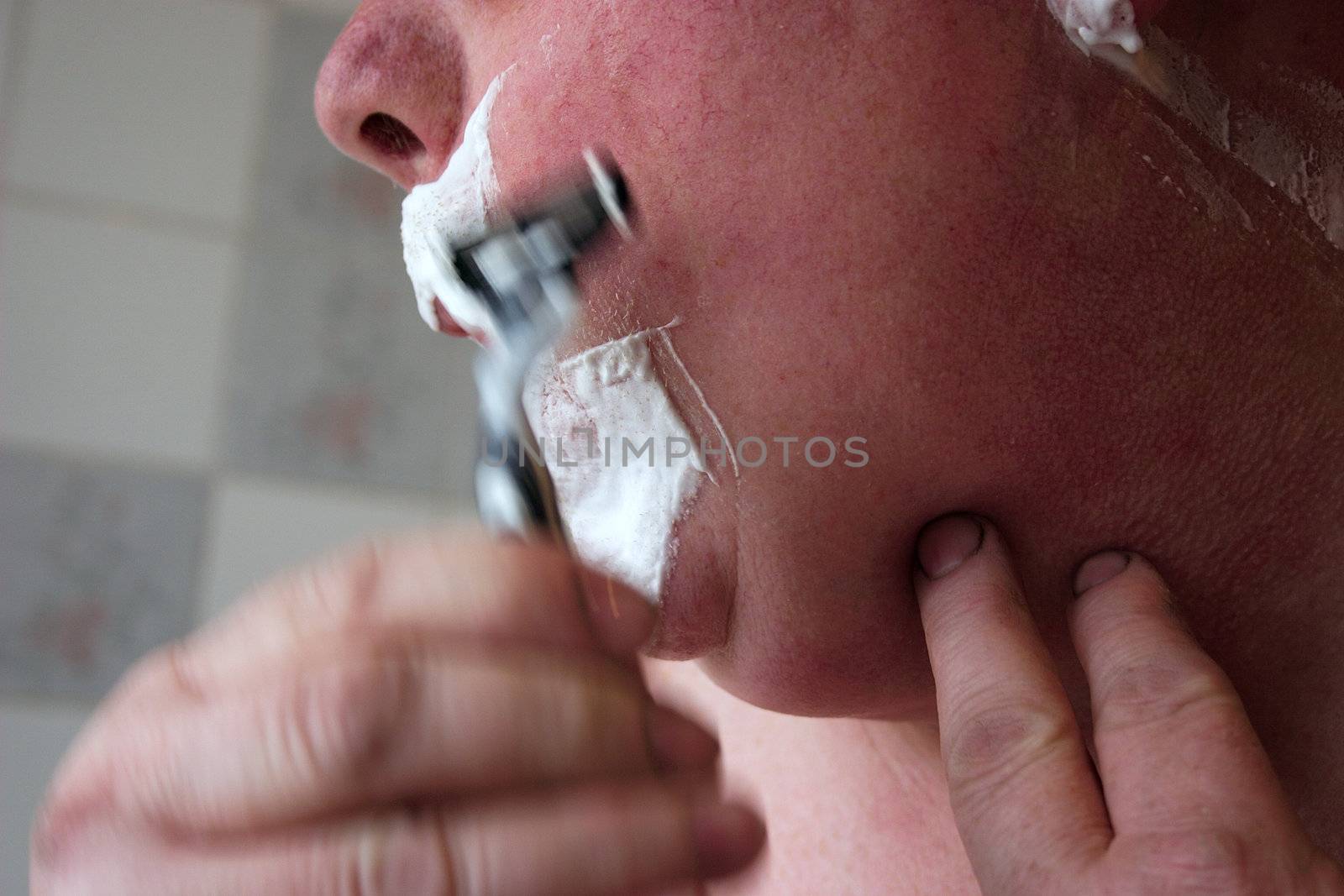 man shaving showing the movement of the razor
