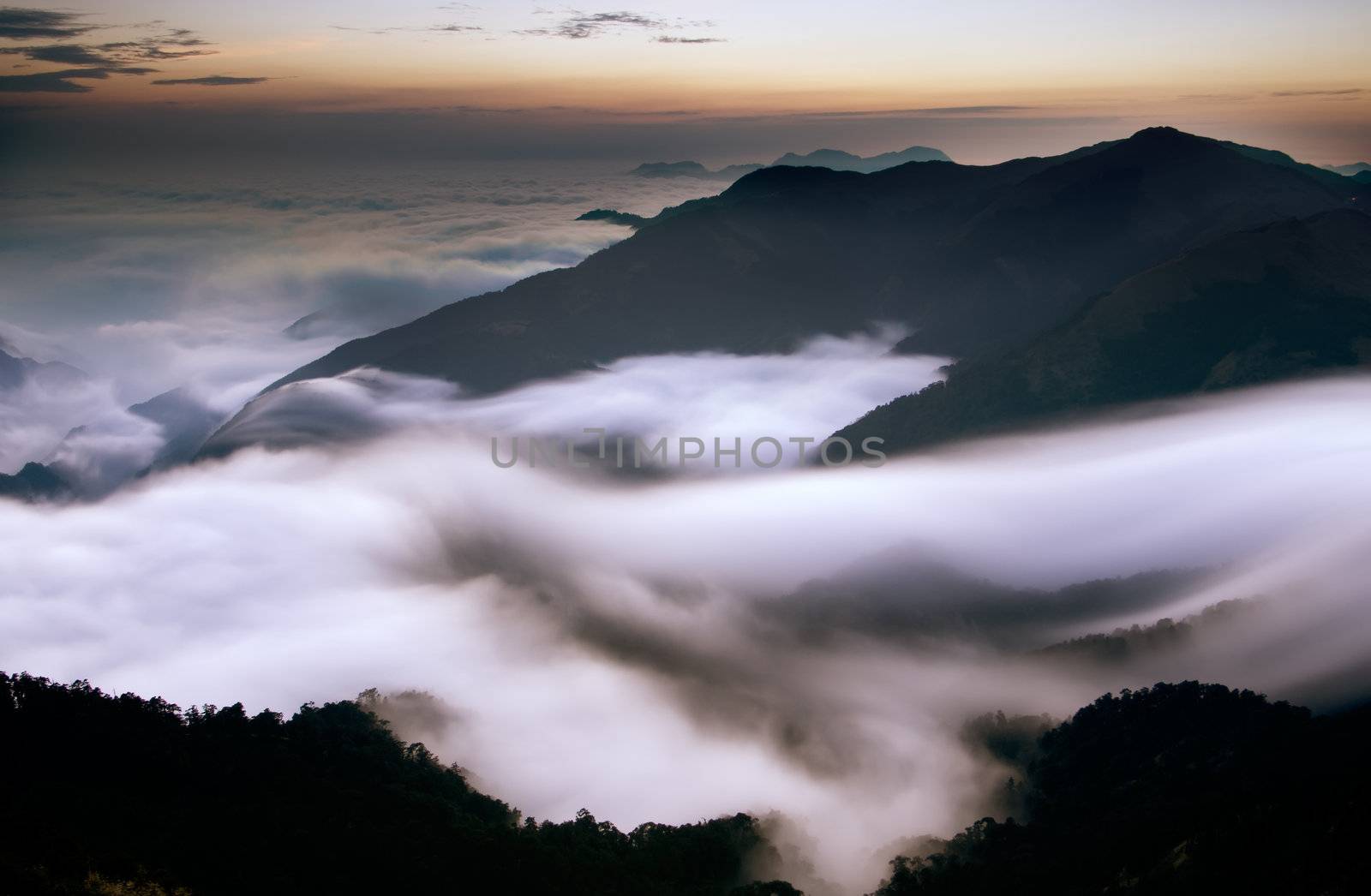 It is beautiful mountain landscape full of clouds.