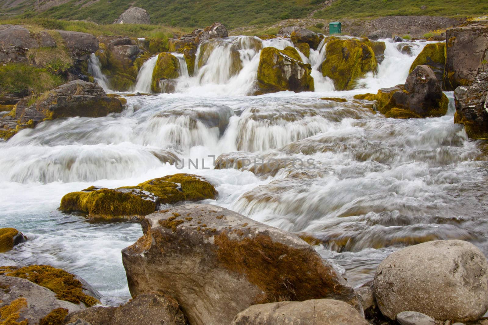 Clean and rapid water in Dynjandi waterfall - Iceland.