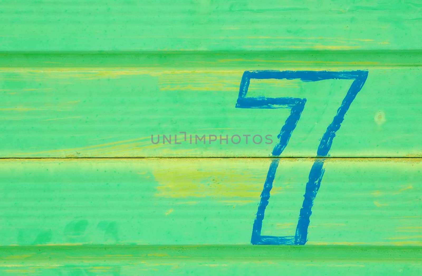 number 7 painted on a battered metal door