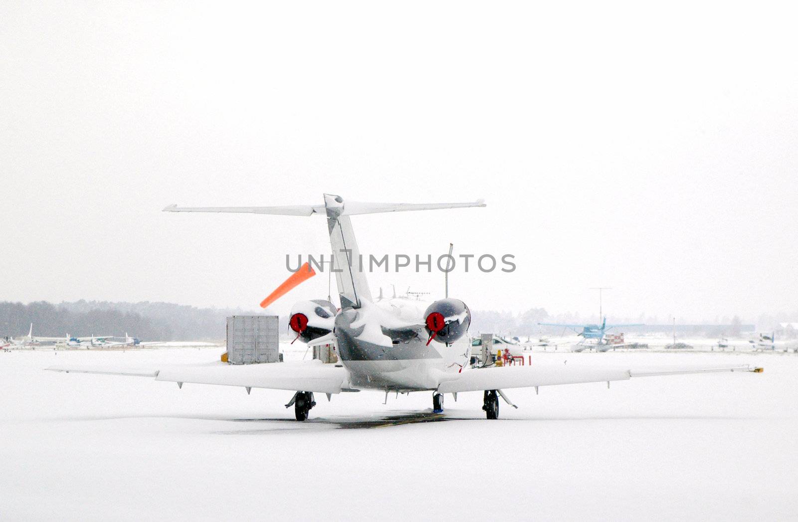 business jet snowed in at an airport