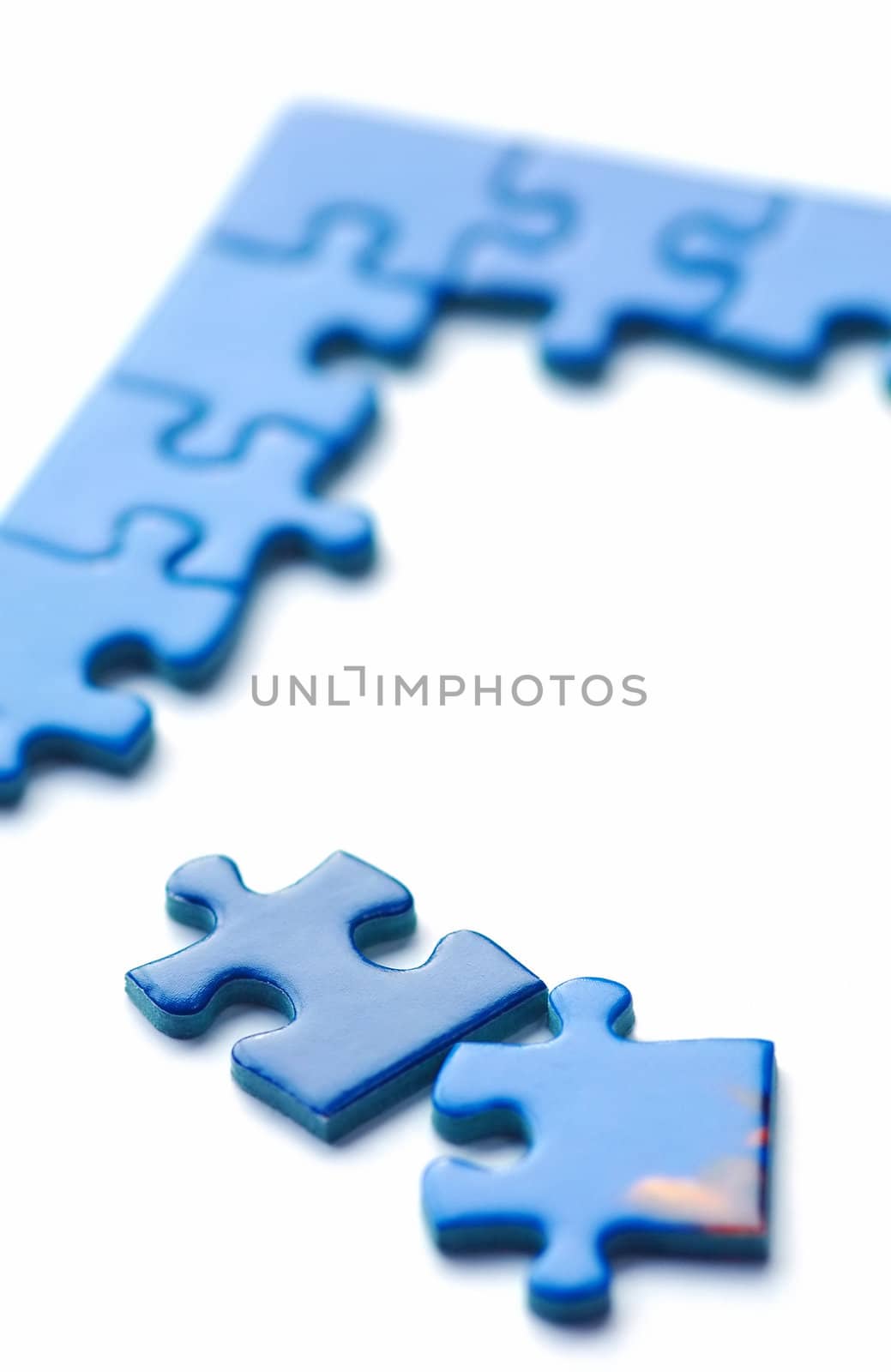 incomplete jigsaw puzzle pieces on white