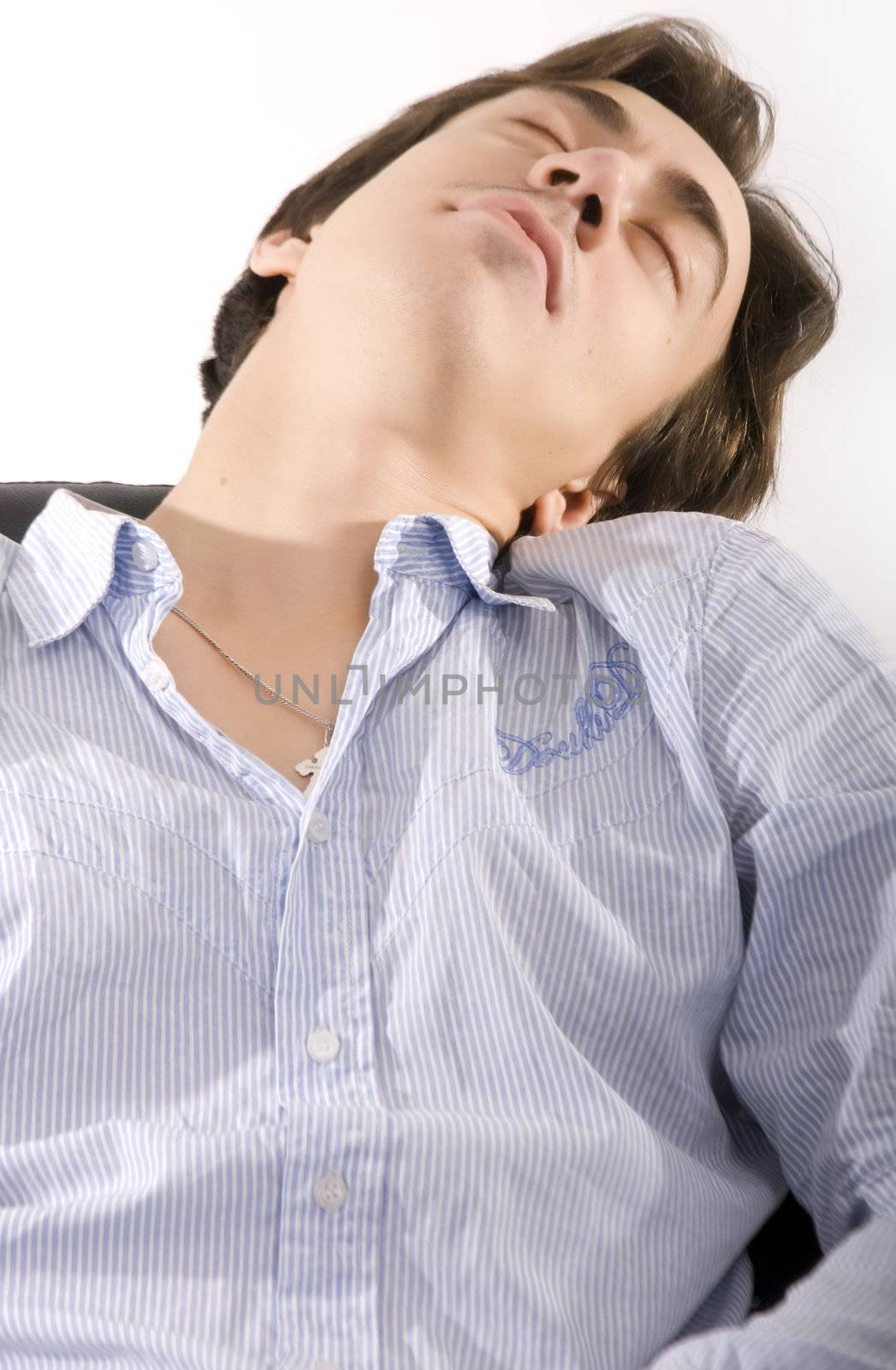 Young businessman sleeping thrown back on the chair 