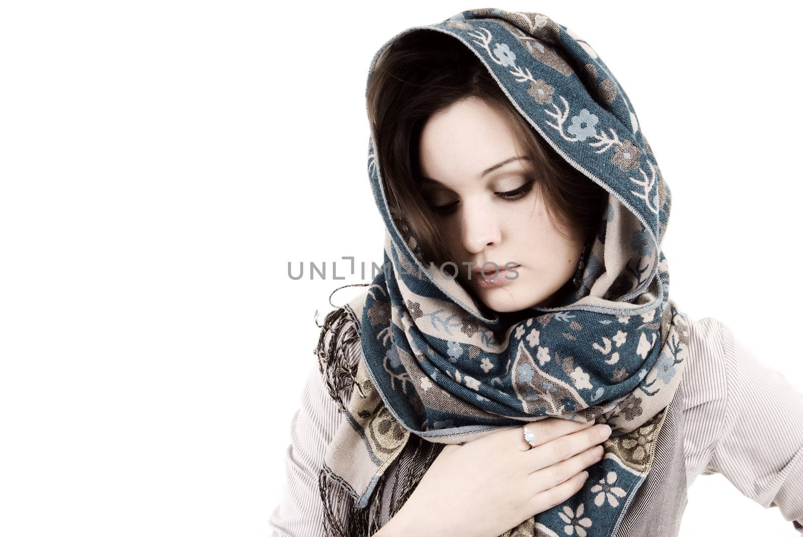 young beautiful brunette wrapped in scarf and looking sad