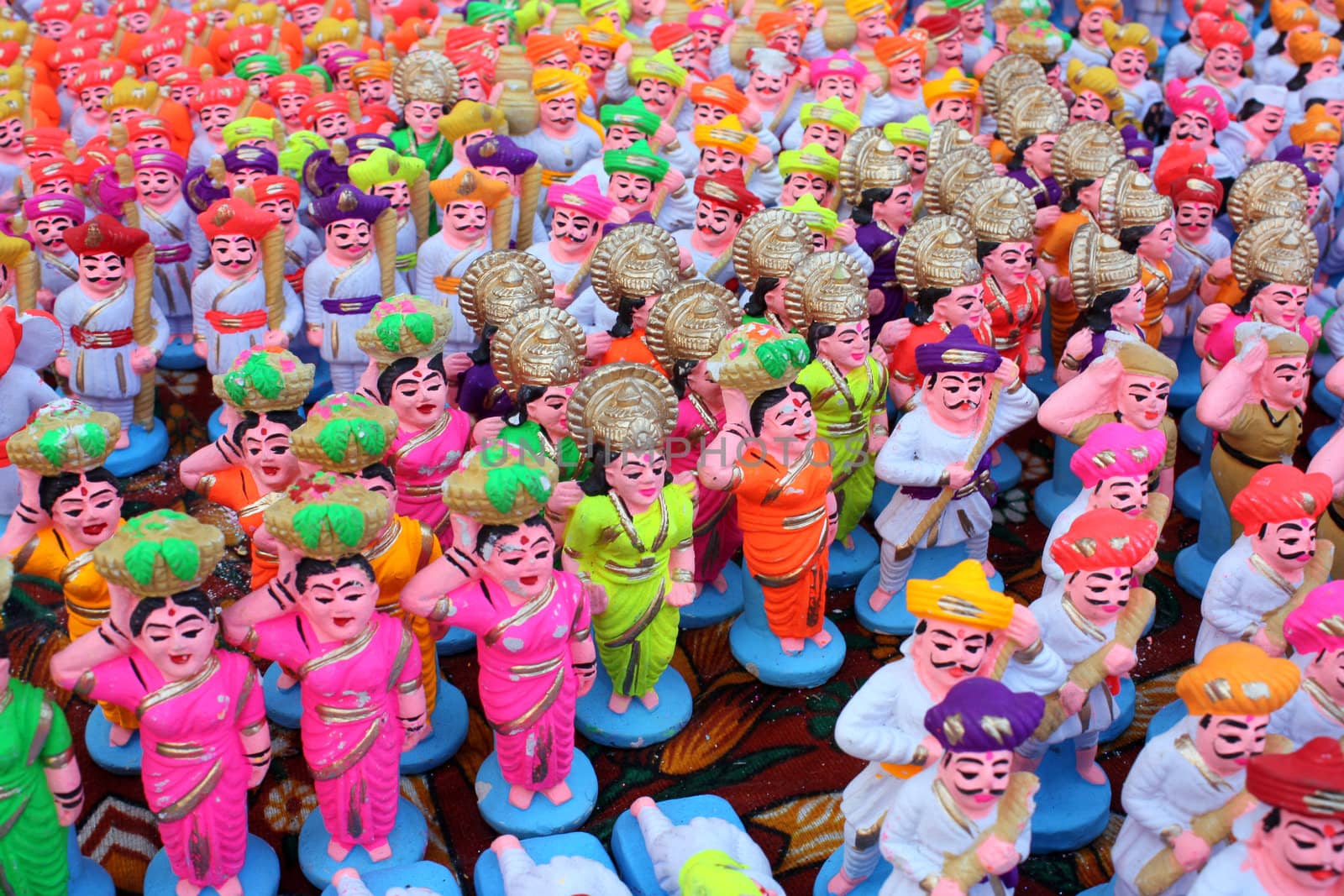 A background of colorful clay idols of native Indian people, traditionally used for decoration in Diwali festival in India.