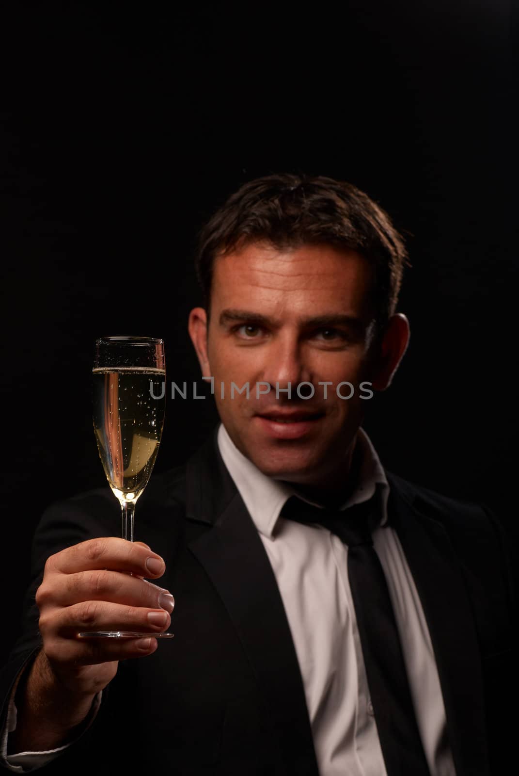 Attractive guy toasting with a glass of champagne