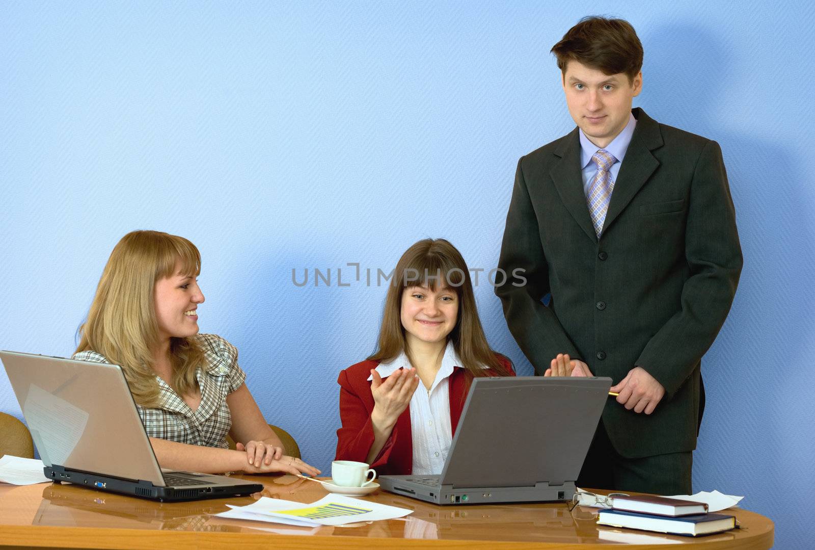 Girls sitting at a desktop and their chief