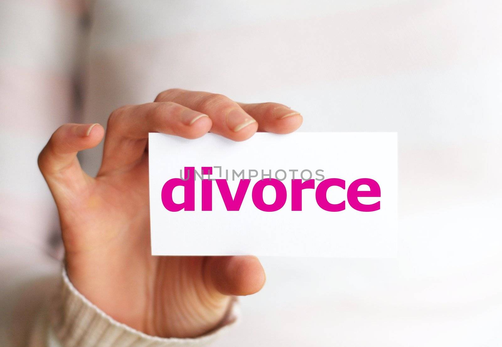 divorce concept with hand holding paper sign