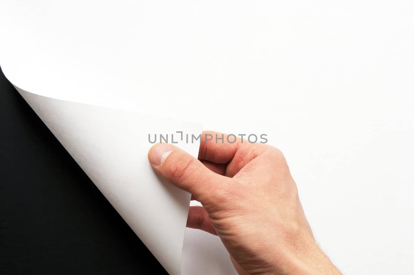 hand turning over blank sheet of paper