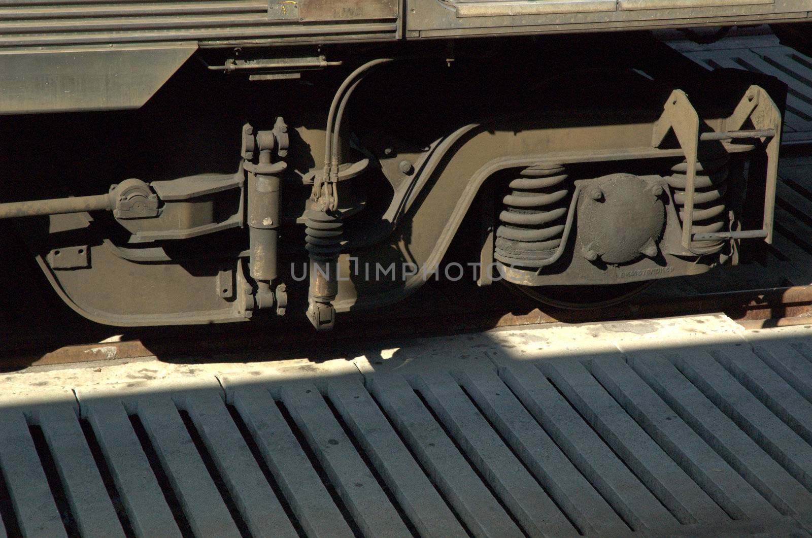 Closeup of train wheels on wooden platform