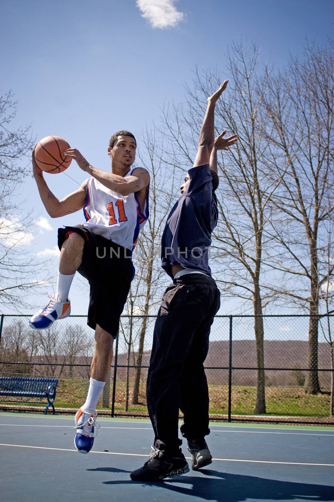 Two young basketball players compete fiercely against each other.
