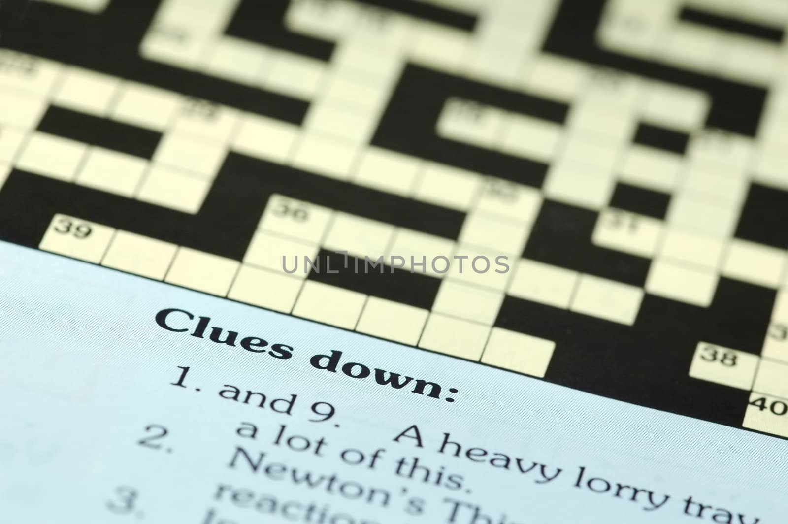 crossword puzzle closeup with clues down 