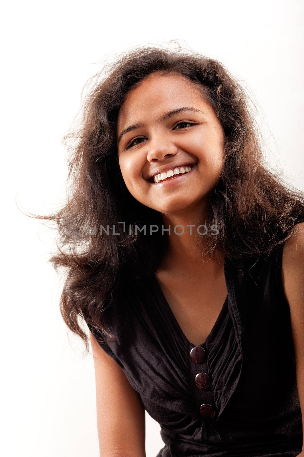 Shy smile of beautiful Indian girl, isolated on white background