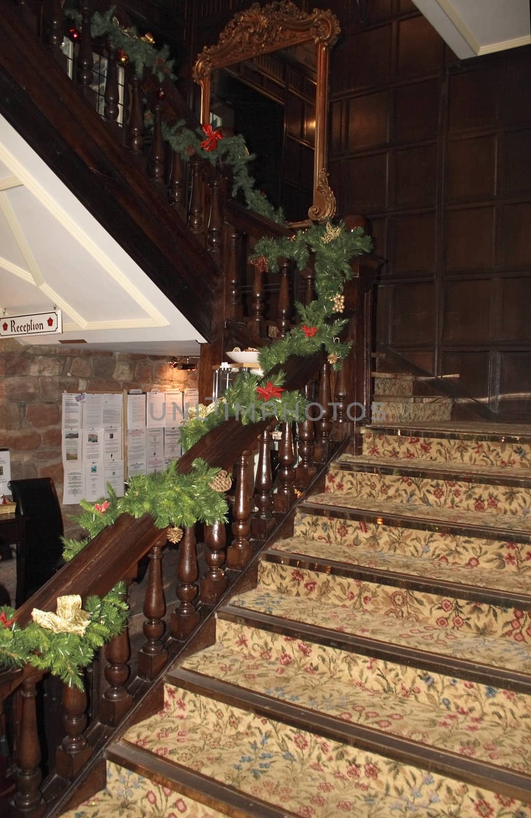 old staircase with carpet and decorated for the christmas season