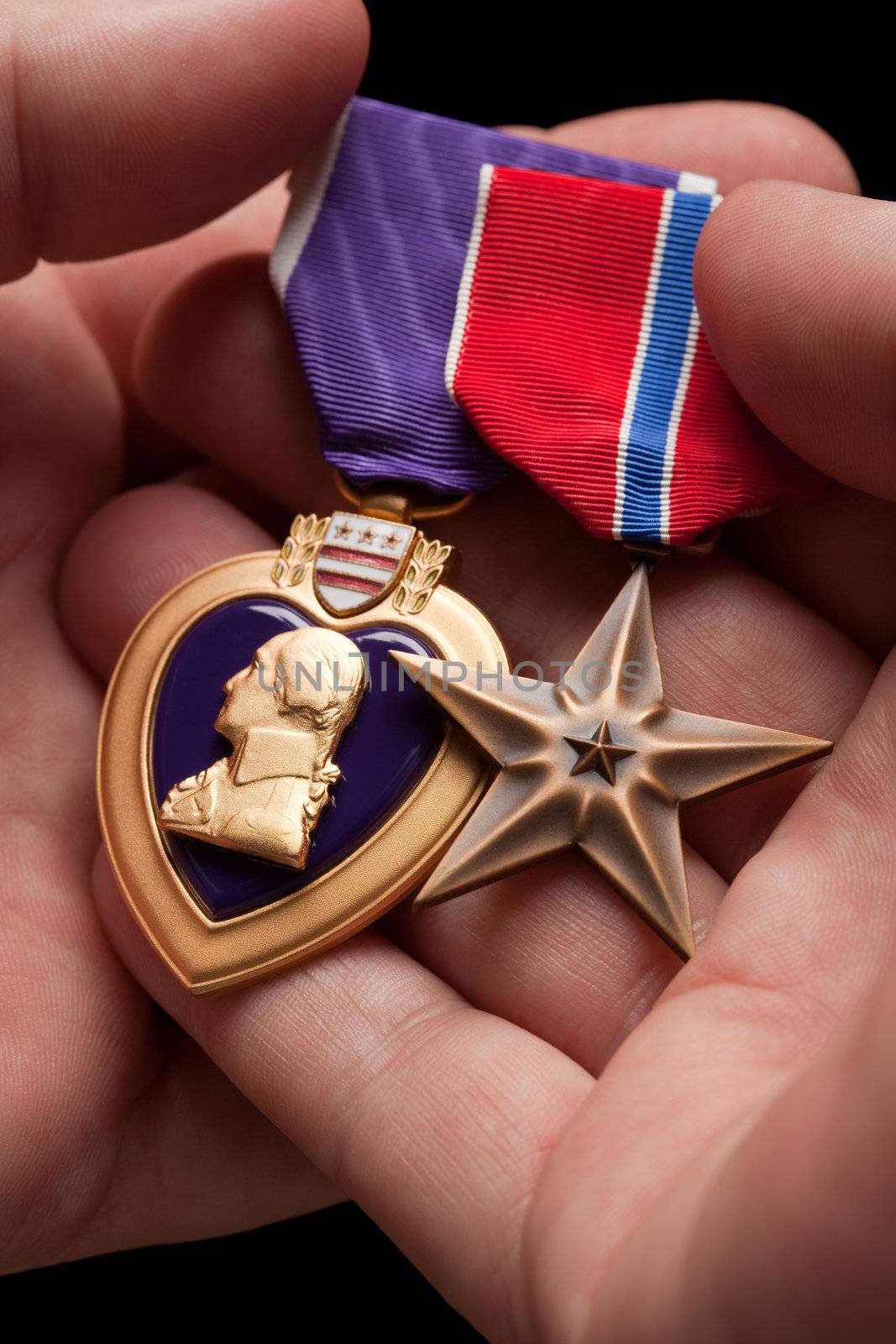 Man Holding Purple Heart and Bronze War Medals by Feverpitched