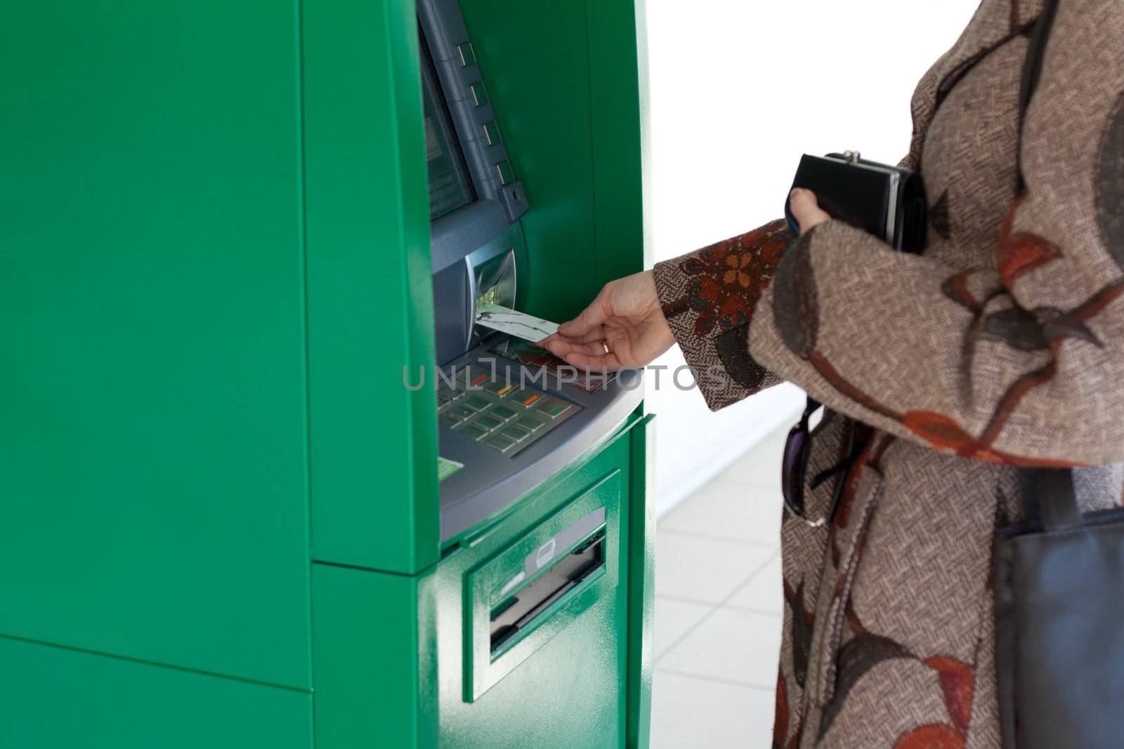 Girl uses bank terminal with credit card