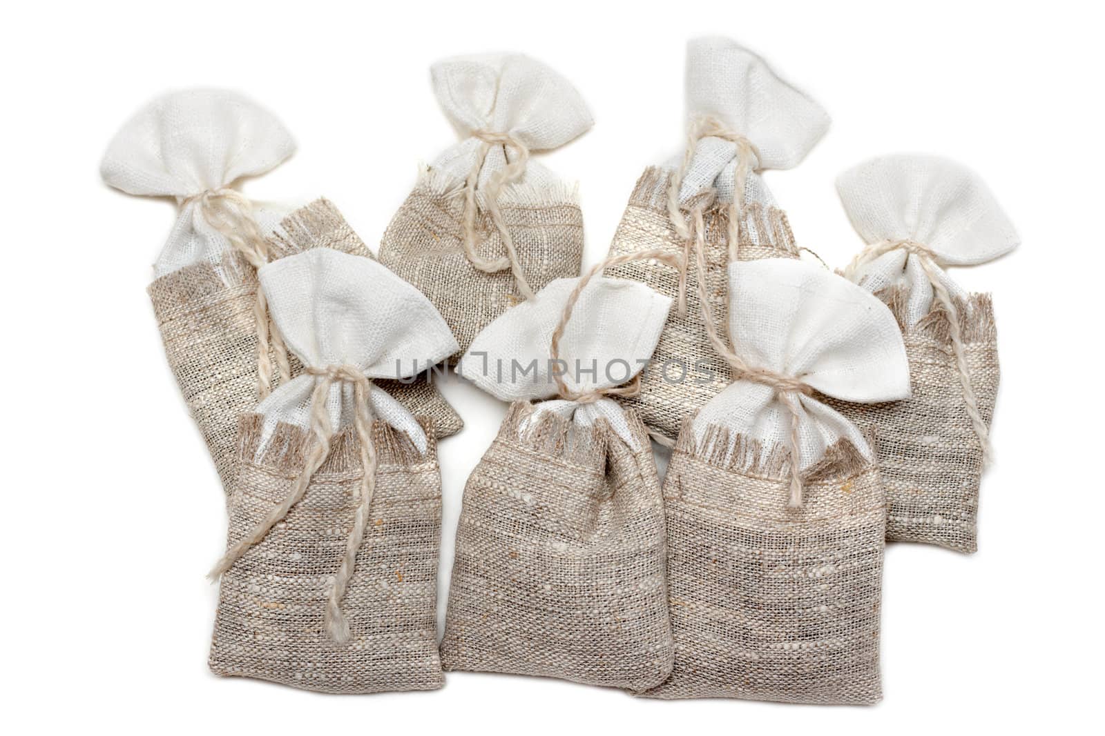 Sac pervaded spice and tied rope on white background