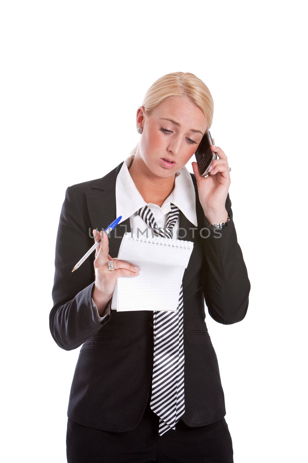 Beautiful young blond businesswoman on the phone looking slightly confused