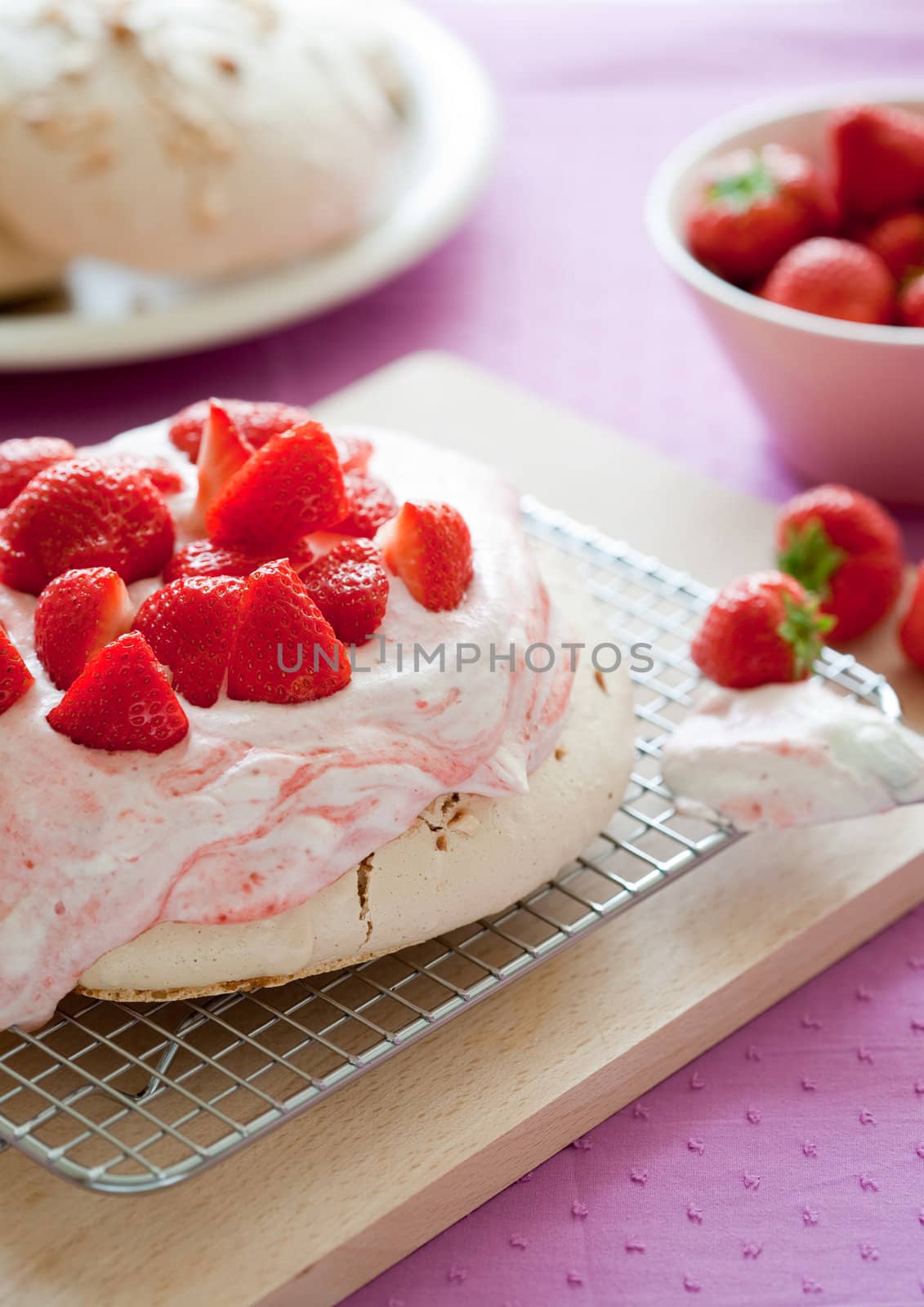 Delicious strawberry pavlova topped with fresh strawberries
